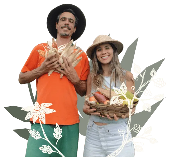 Seu Zé e Isabela Fernandes segurando frutas e hortaliças cultivadas na Ecovila